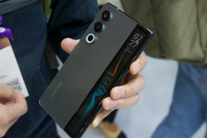 Someone holding the Tecno Phantom Ultimate rollable phone concept.