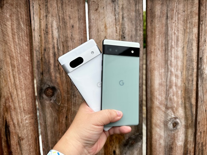 Sage green Pixel 6a and Snow Pixel 7a held in hand.