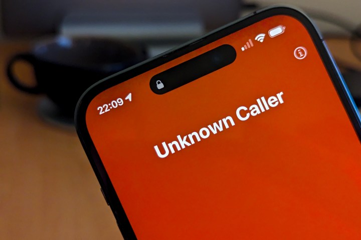 iPhone 14 Pro Max showing incoming call from Unknown Caller.