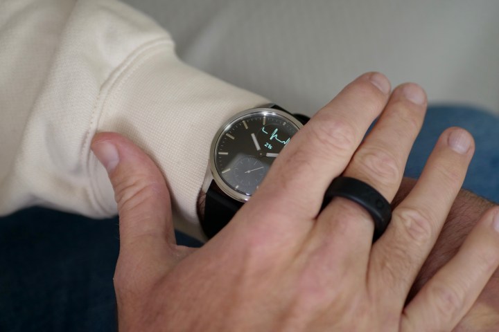 A person wearing the Withings ScanWatch 2, using the ECG function.