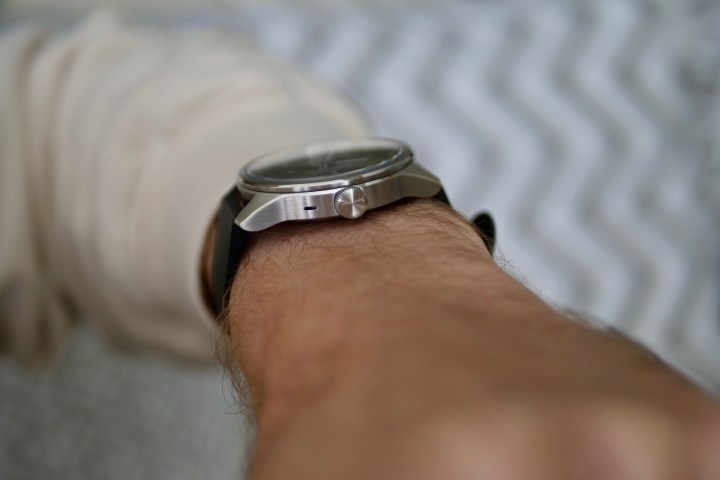 A person wearing the Withings ScanWatch 2, showing the side view.