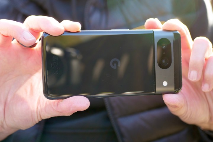 A person taking a photo with the Google Pixel 8.