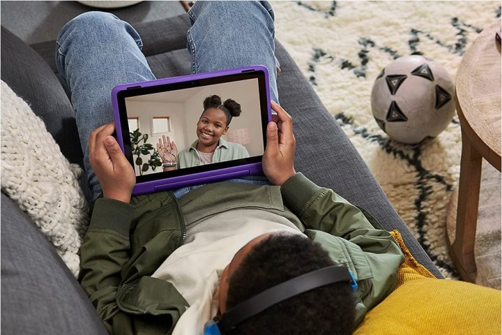 A young boy uses the Fire HD 10 Kids Pro to video chat,