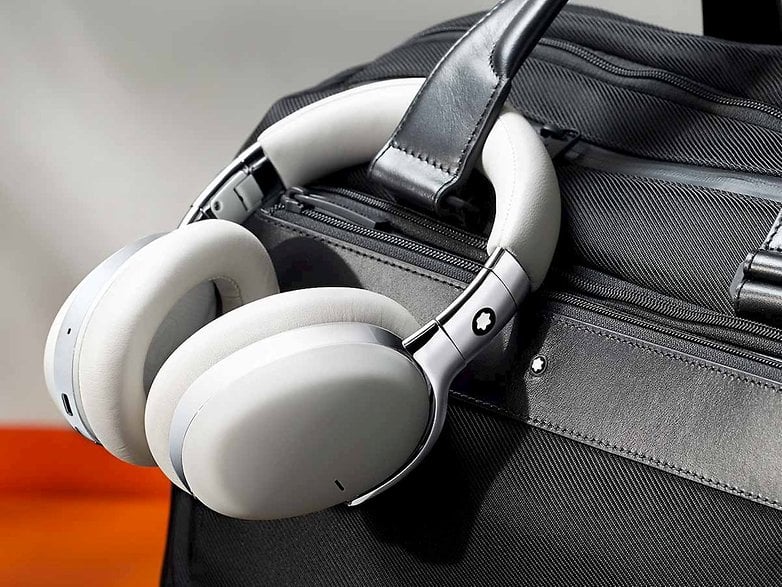 A Montblanc wireless headphone attached to a purse