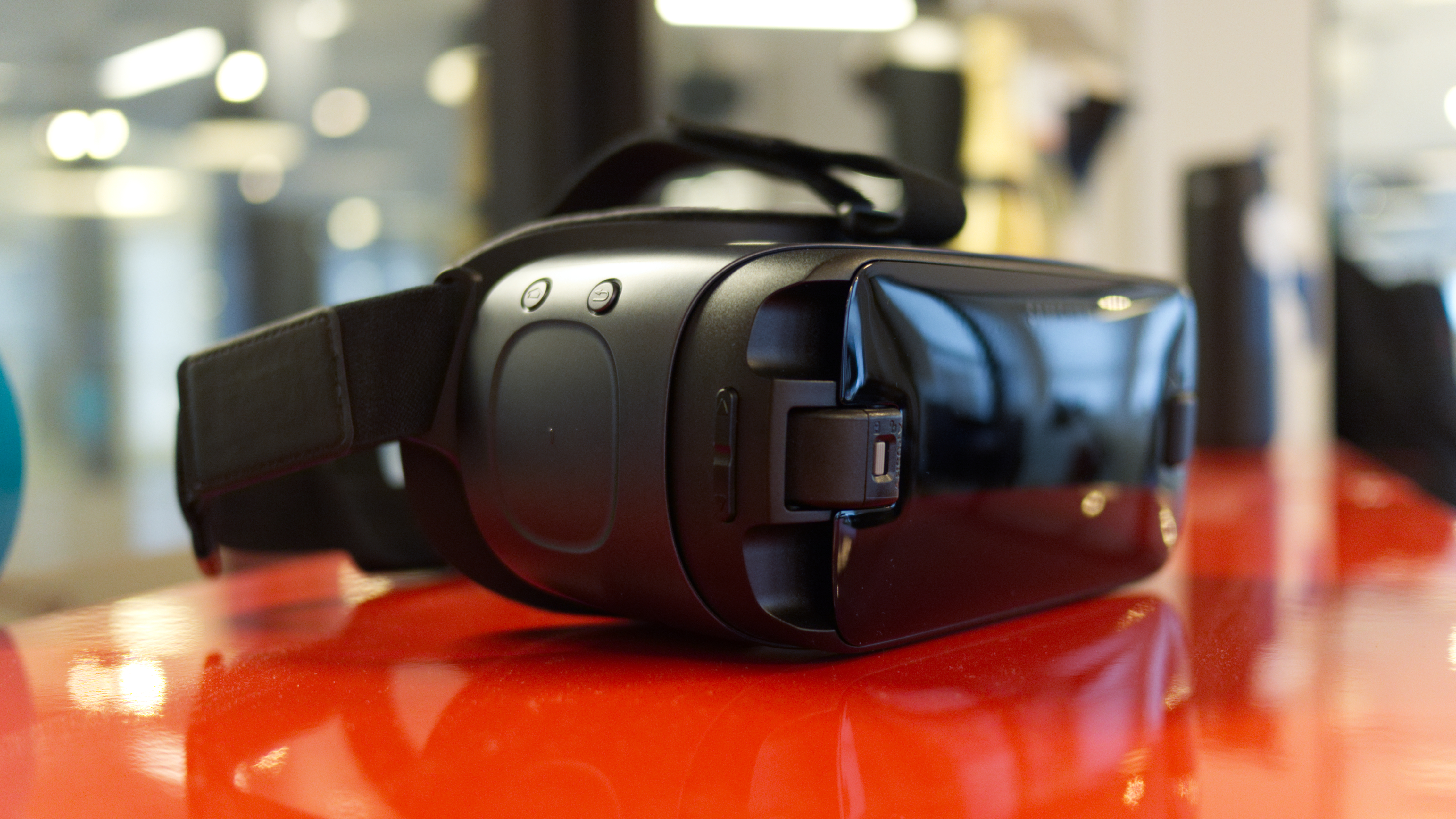 The Samsung Gear VR headset on a red desk