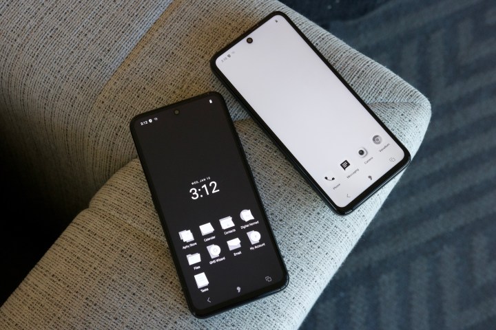 Two phones running Apostrophy OS, sitting next to each other on a chair.