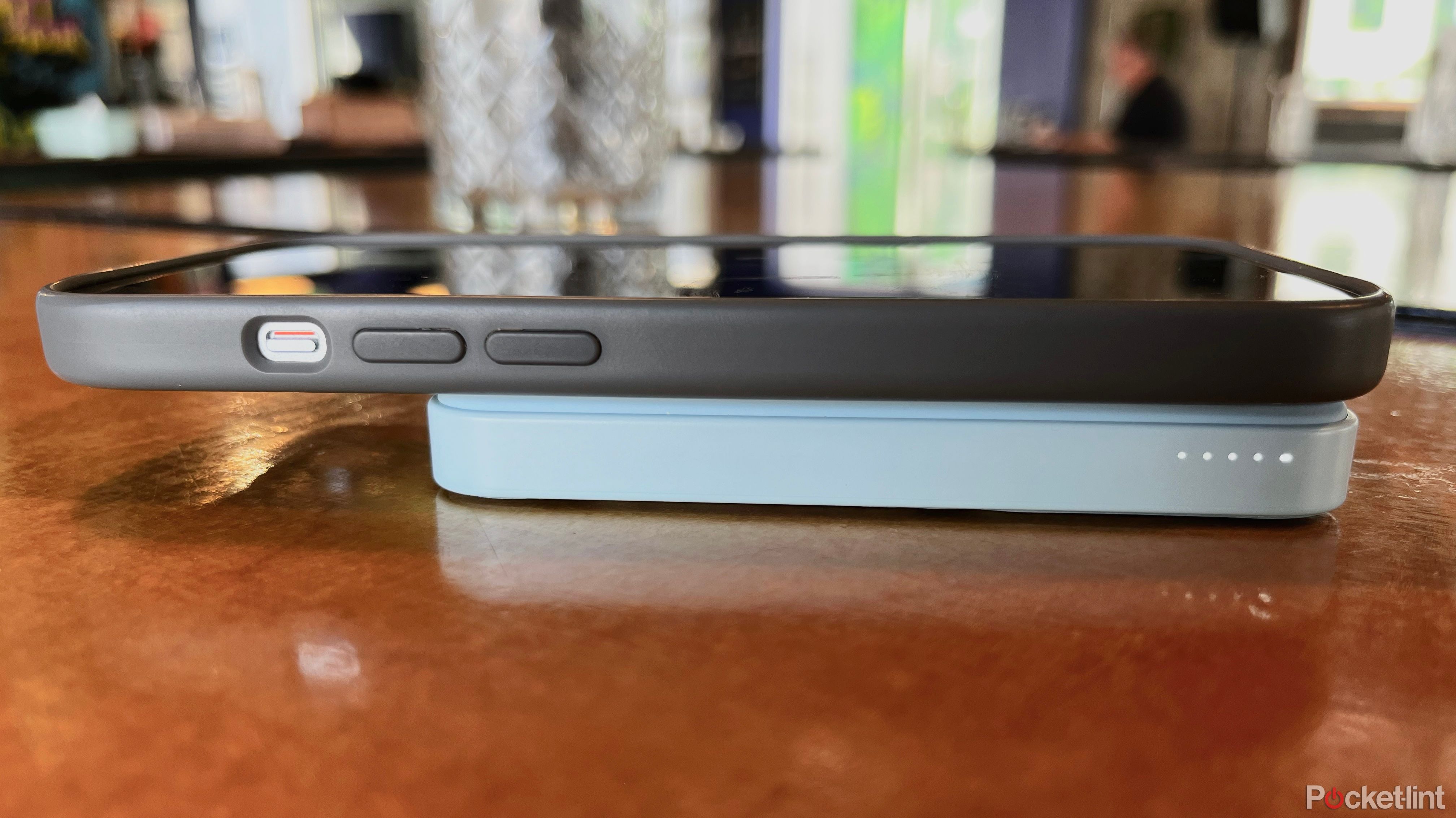 An iPhone 15 attached to and getting charged by an Anker Magnetic Battery.