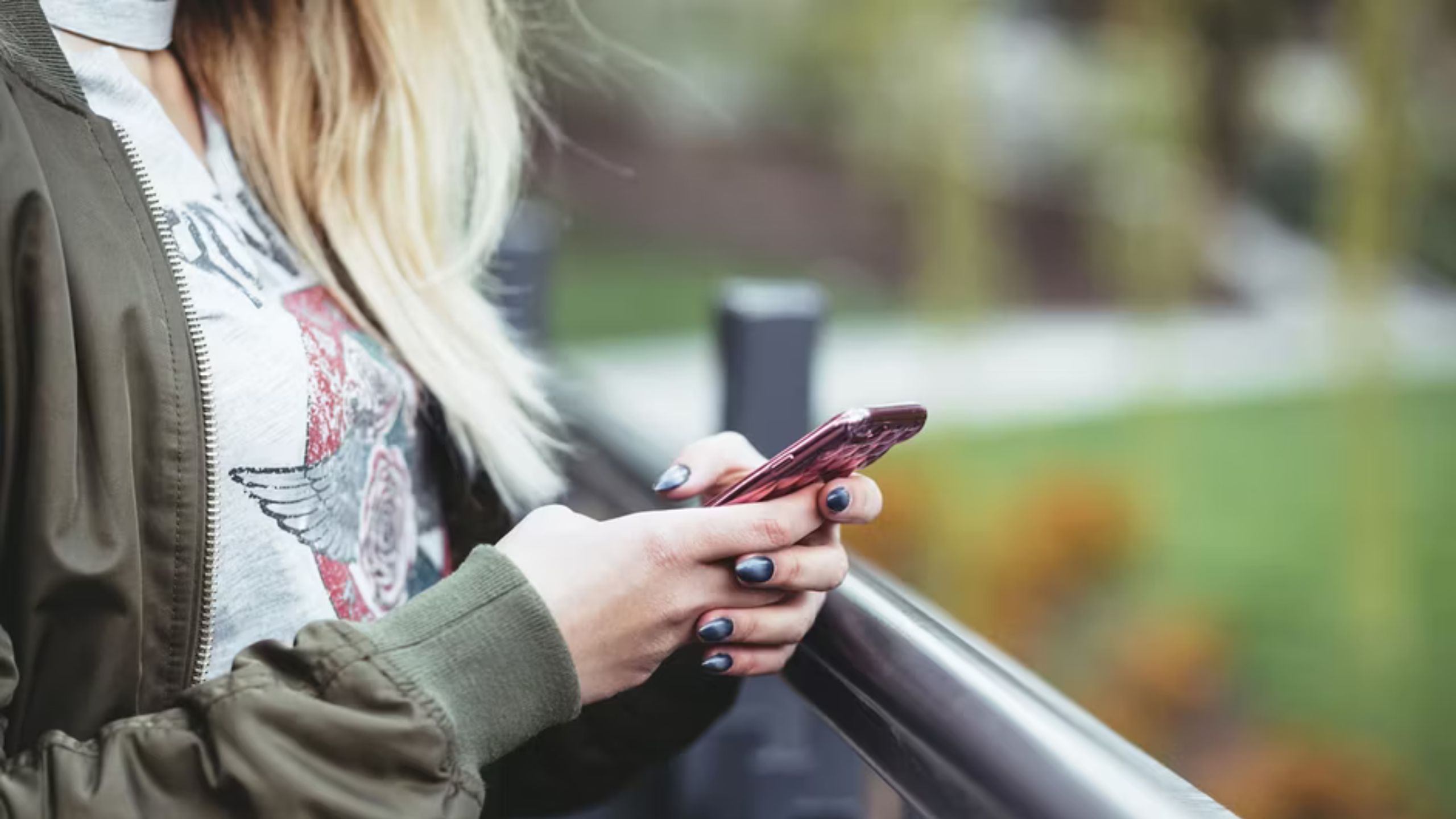group text woman holding phone in both hands